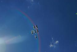 Photo of four Blue Angel jets in a rainbow of lens flare