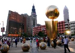 Photo of LeBron James' Nike billboard and Cleveland, Ohio's city buildings with The Finals giant trophy in front of Quicken Loans Arena