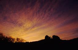 Sedona, Arizona's Red Rock Crossing backlit by a dramatic sunrise.